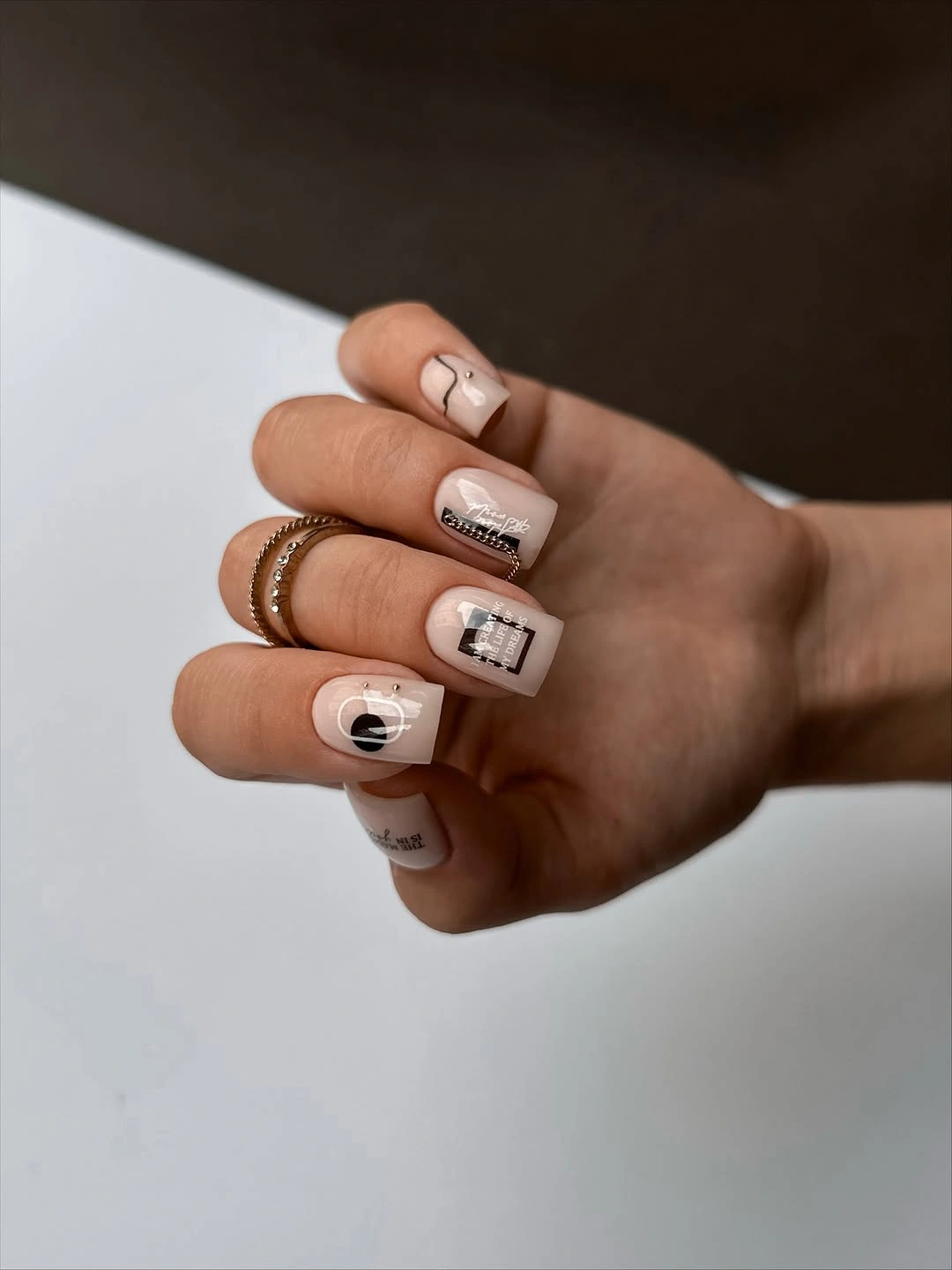 Short creamy square nails with miniature black line marks