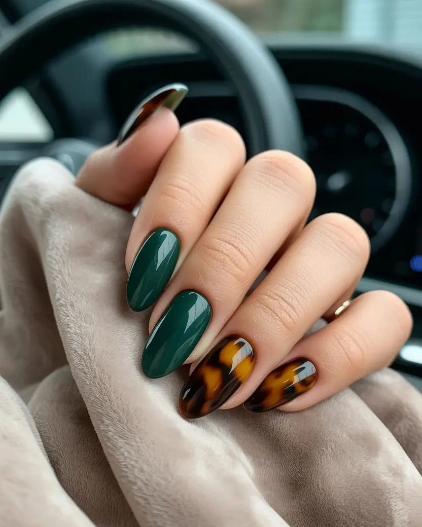 Emerald almond nails with amber patterned accent nails
