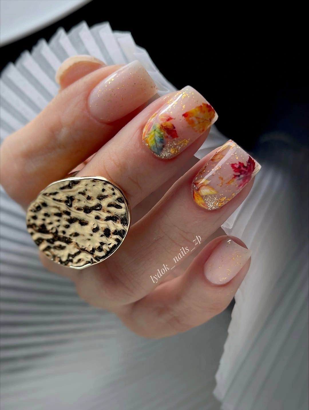 Milky nude square nails with tiny orange red and brown accents