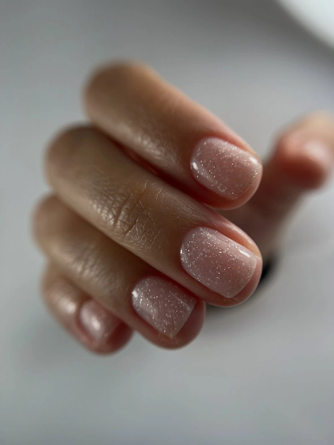 Short warm taupe almond nails with subtle shimmer
