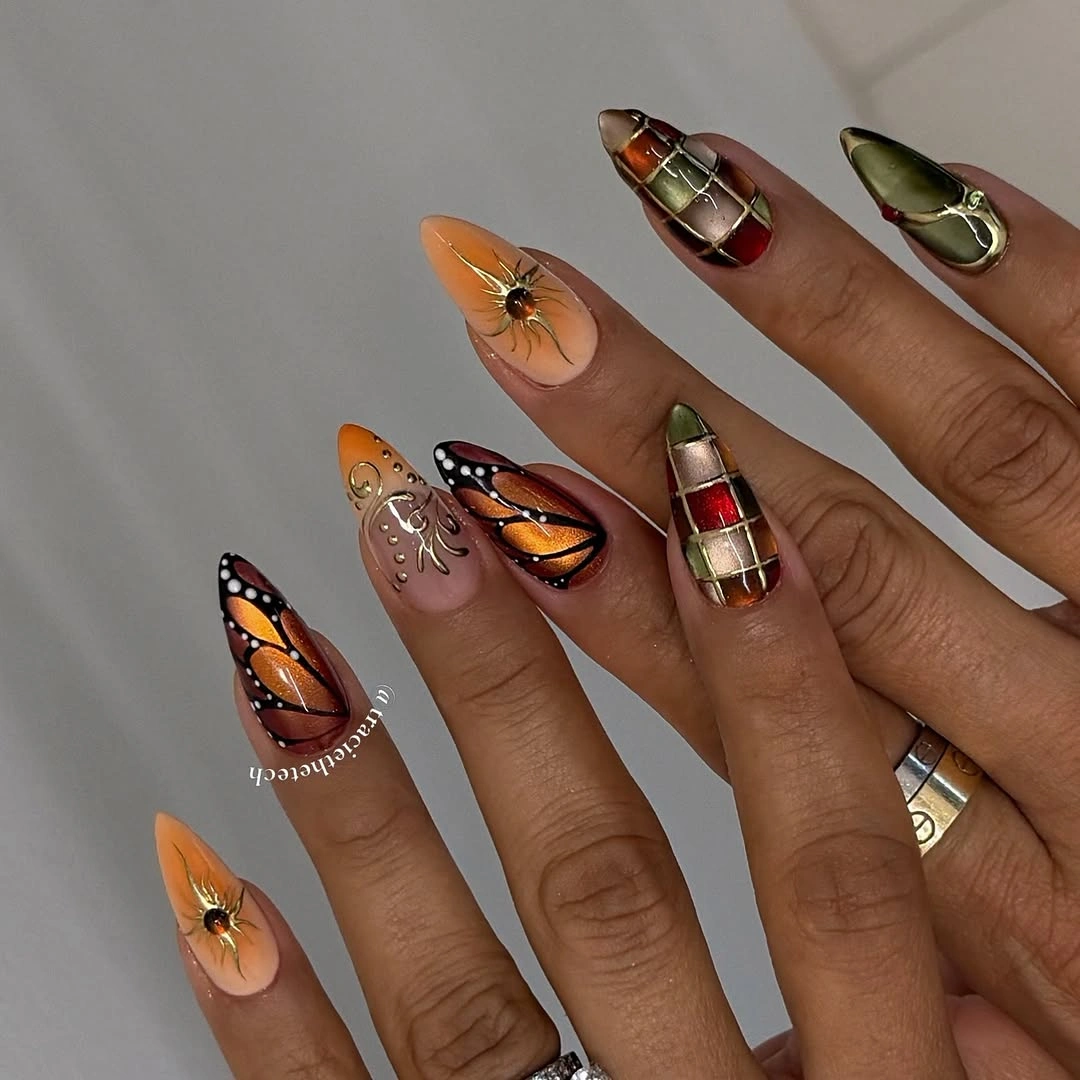 Long pointed orange olive tan and black graphic nails