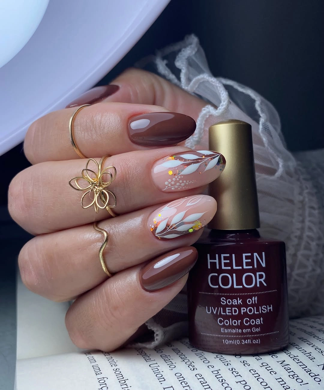 Short nude plum nails with white curves and gold dots
