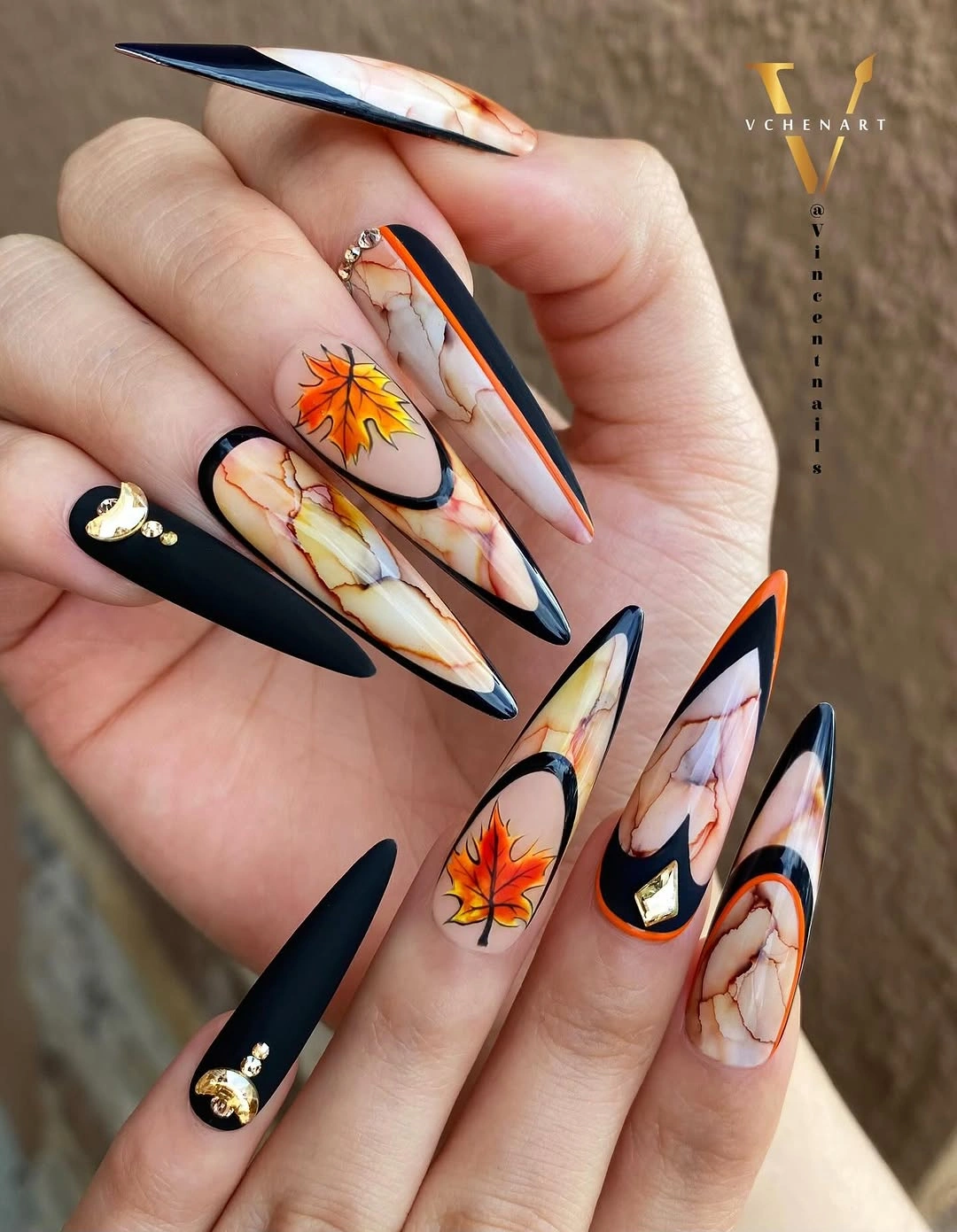 Long black nude orange botanical pointed fall nails