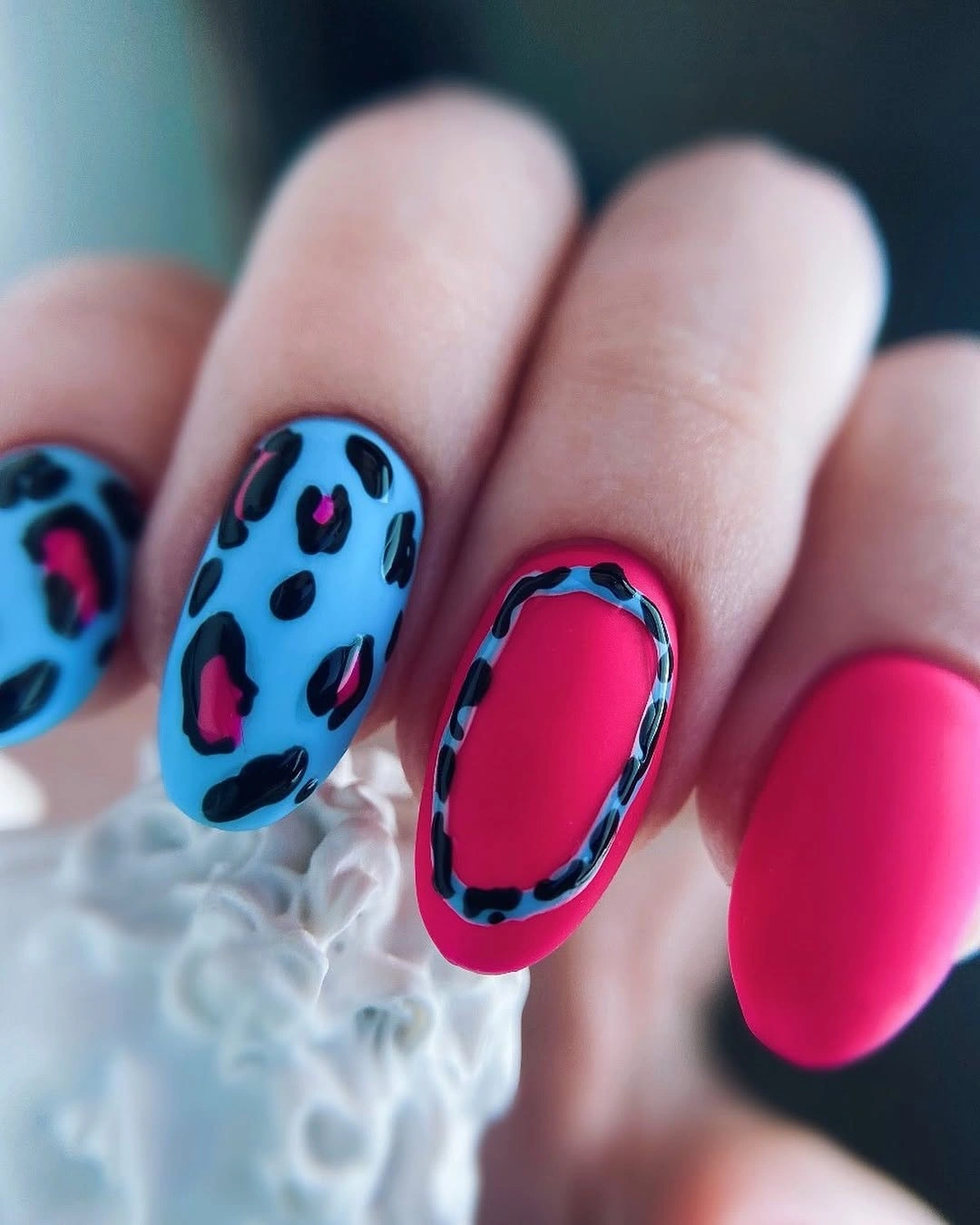 Cyan pink black short nails with leopard-like graphic marks