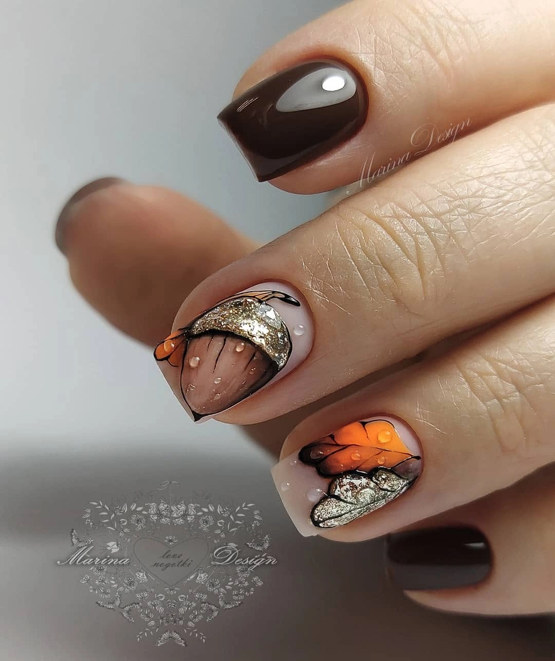 Espresso orange almond nails with metallic diagonal details