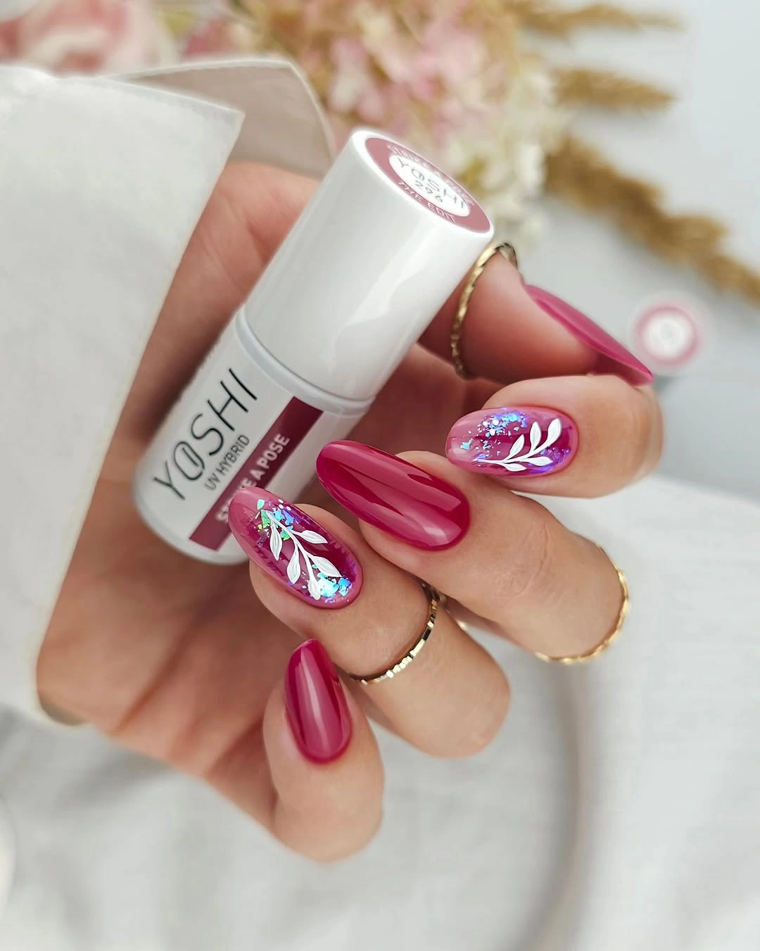 Magenta almond nails with white botanical accent art