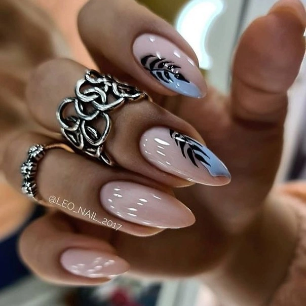 Long pale almond nails with black blue flowing line art
