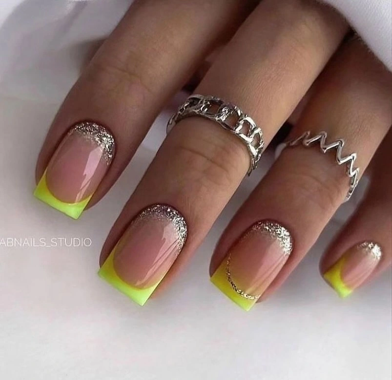 Medium square pale nude nails with neon lime tips