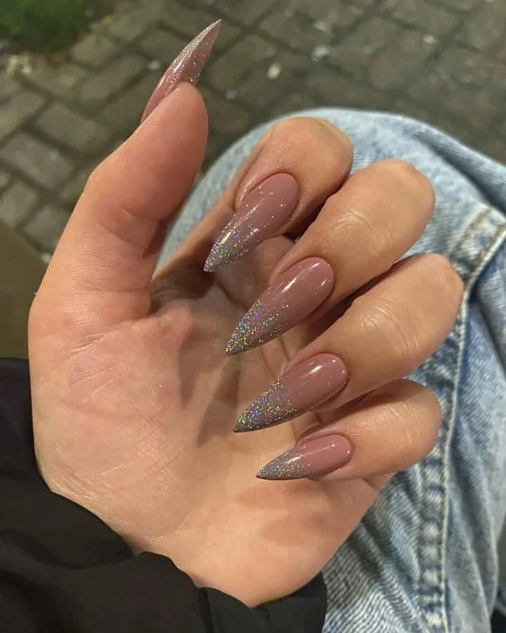 Long pink almond nails with silver glitter side accents