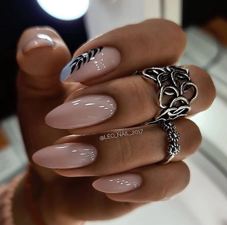 Long beige almond nails with black abstract leaf lines