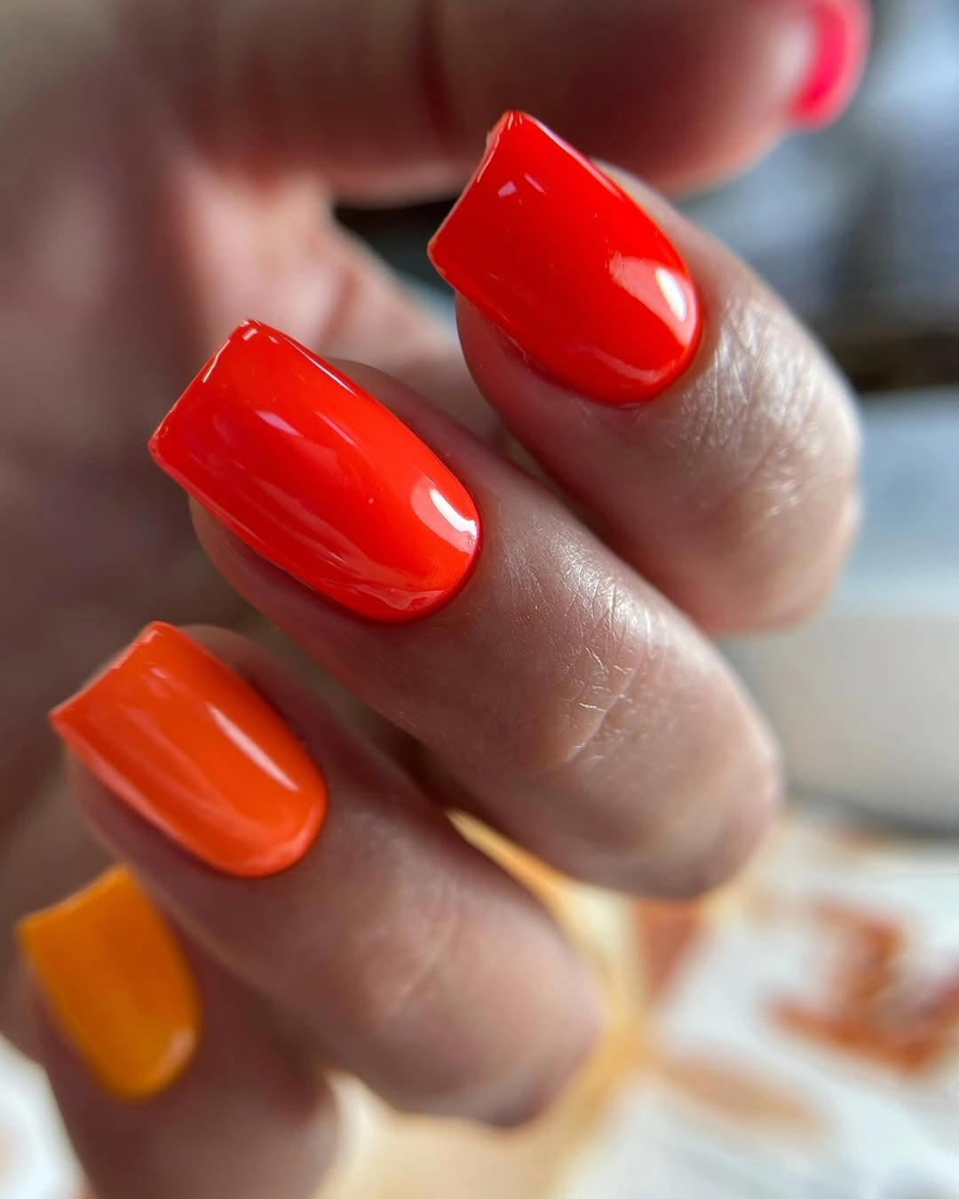 Medium glossy orange square nails in a vivid fall tone