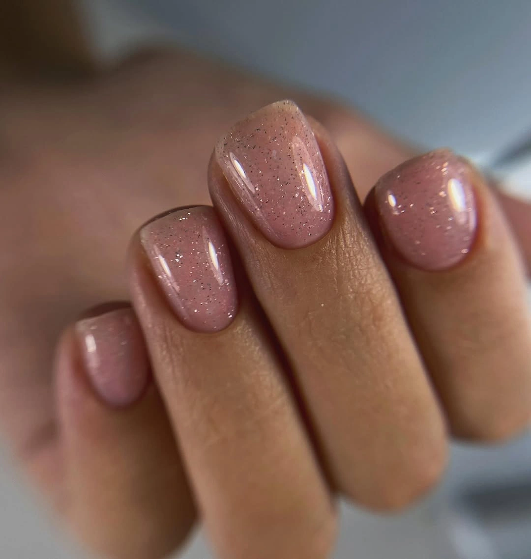 Short rounded dusty mauve nails with delicate shimmer