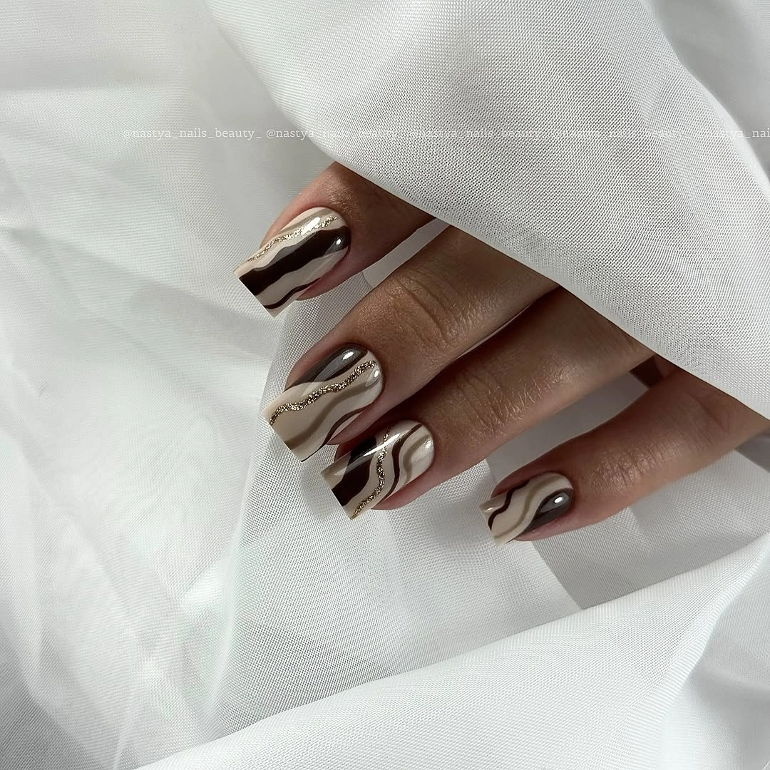Long nude almond nails with brown wavy French outlines