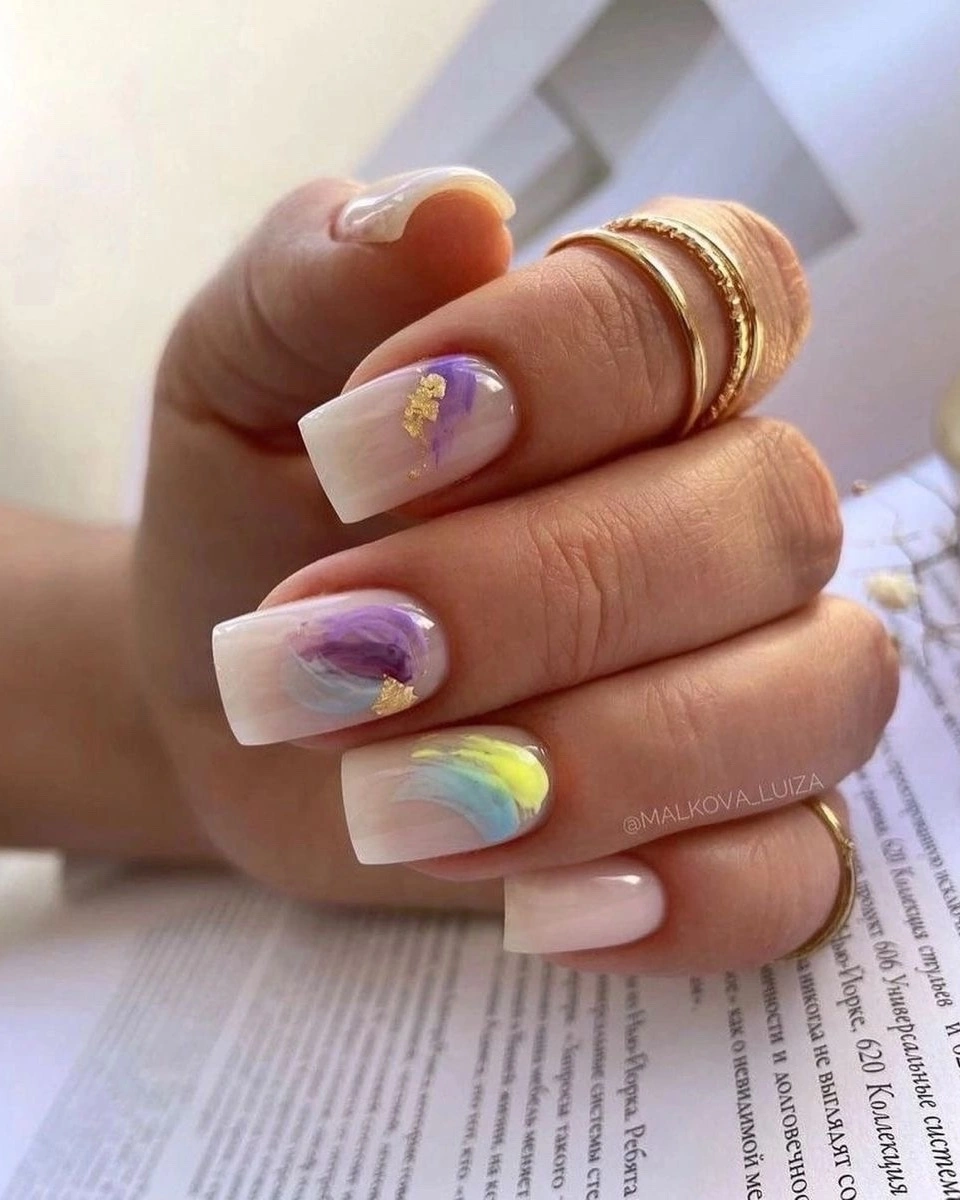 Short nude nails with lavender yellow blue abstract swirls