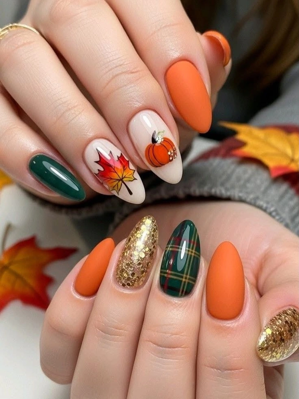 Medium oval fall nails with orange green burgundy and gold accents