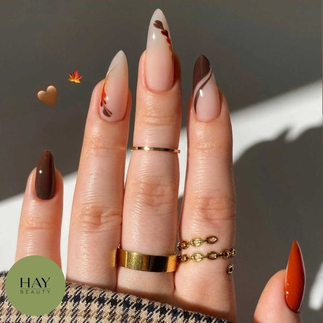 Long stiletto brown nude nails with fine curved accents