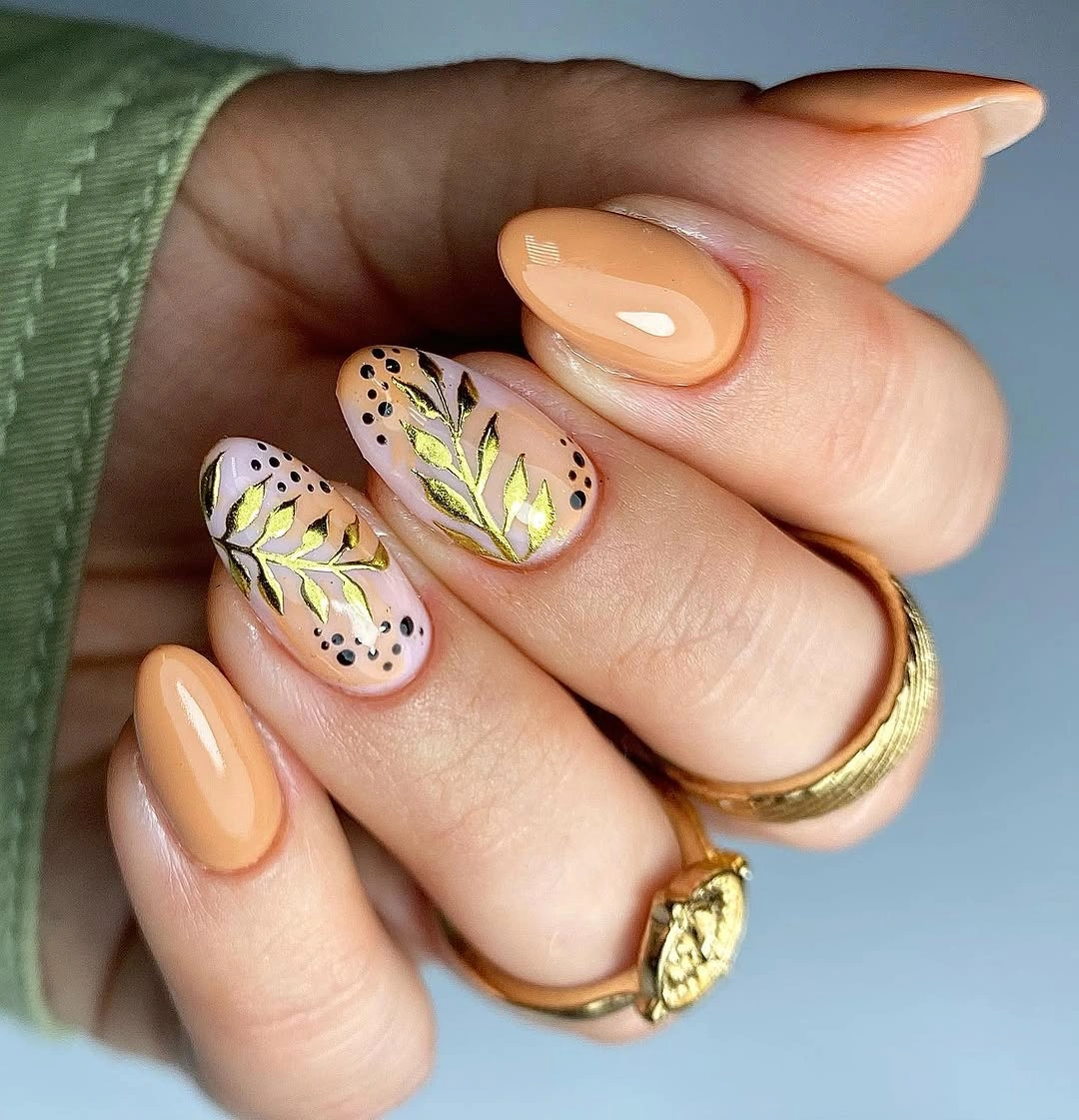 Peach nude rounded nails with green botanical accents