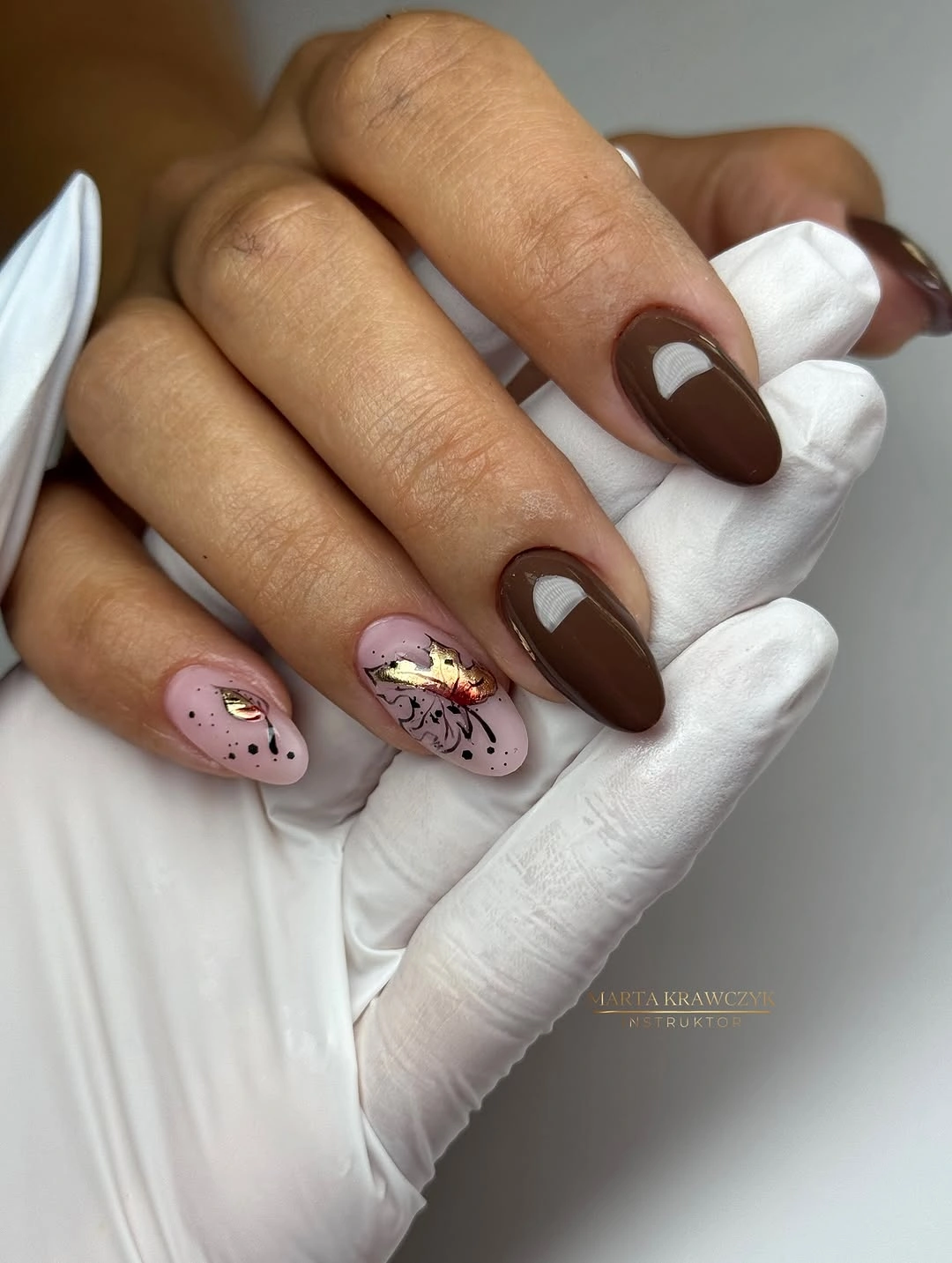 Chocolate brown almond nails with pale botanical accents