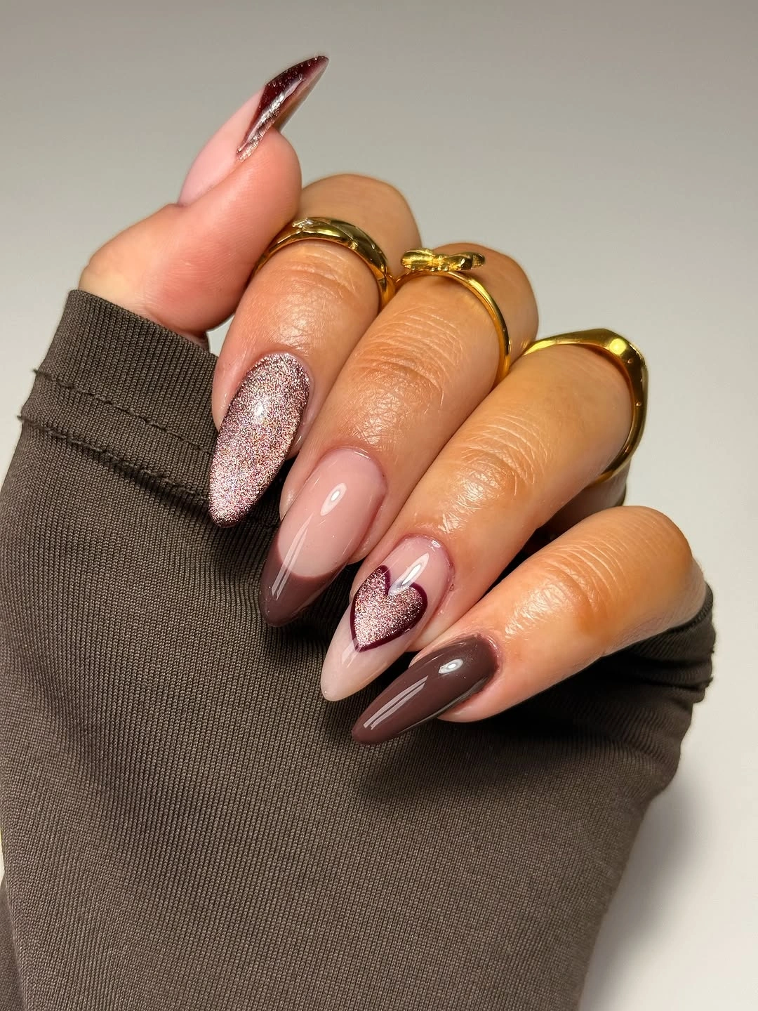 Long almond blush brown and burgundy nails with one sparkle accent