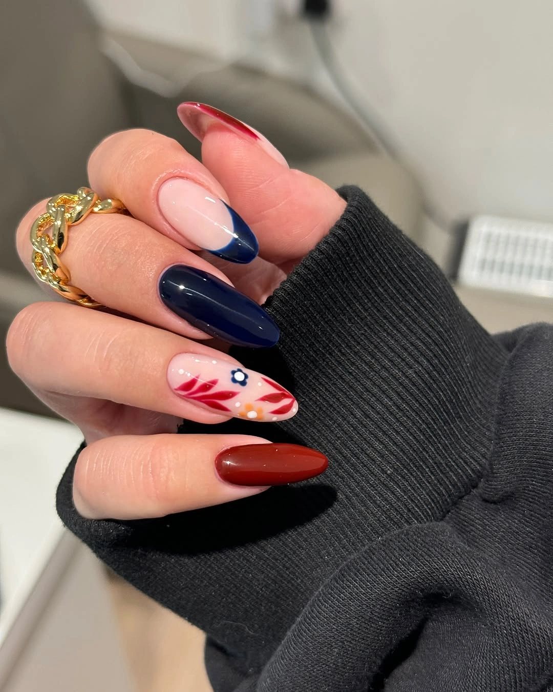 Long almond navy red nails with a pale botanical accent