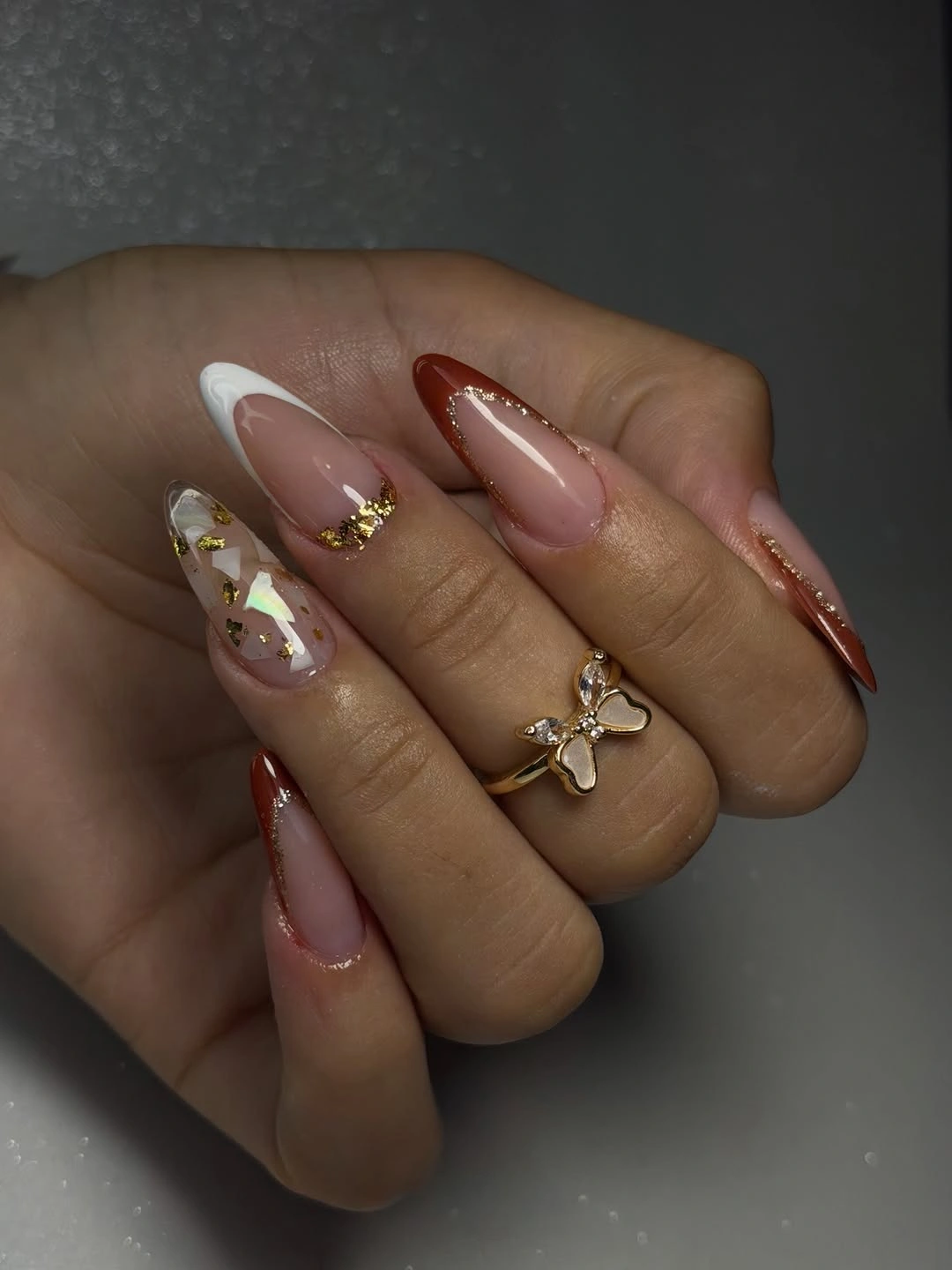 Long almond sheer nails with gold foil botanical panels