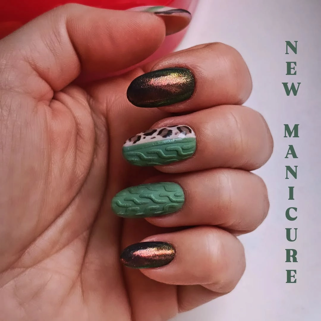 Short rounded dark chrome nails with raised green texture