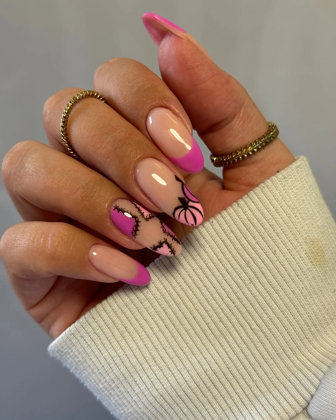 Long pink almond nails with black botanical line accents