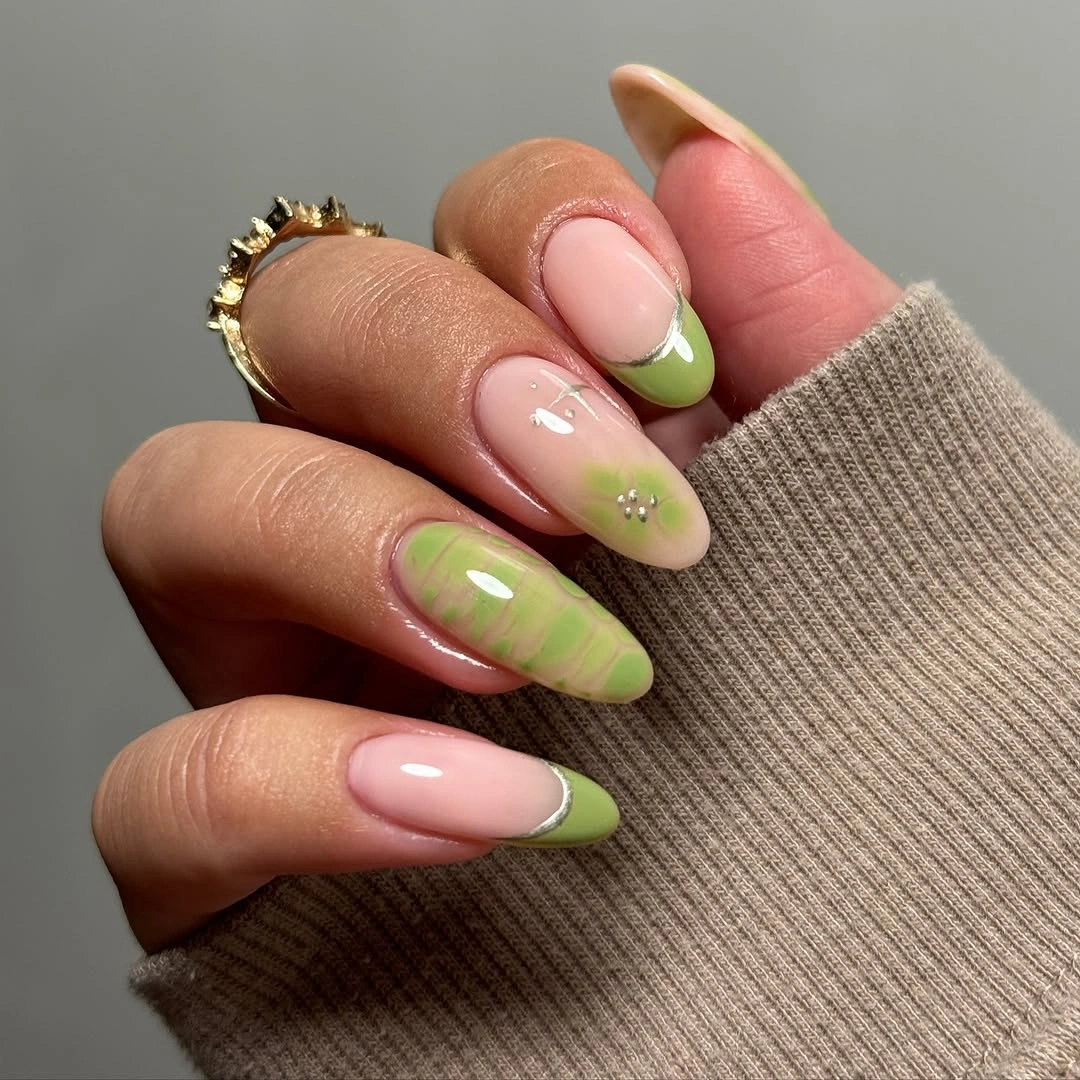 Long pale pink almond nails with muted green French tips