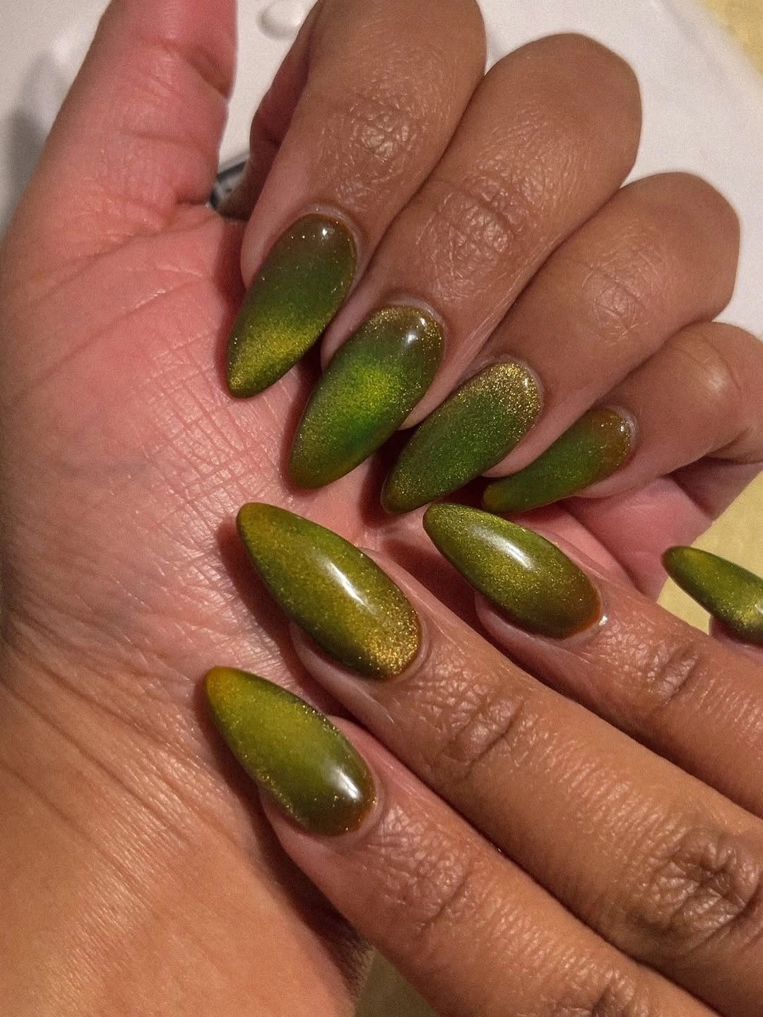 Long glossy olive almond nails with yellow green reflections