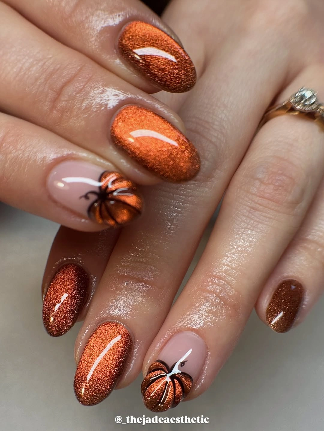 Chocolate almond nails with bronze shimmer and pumpkin accent