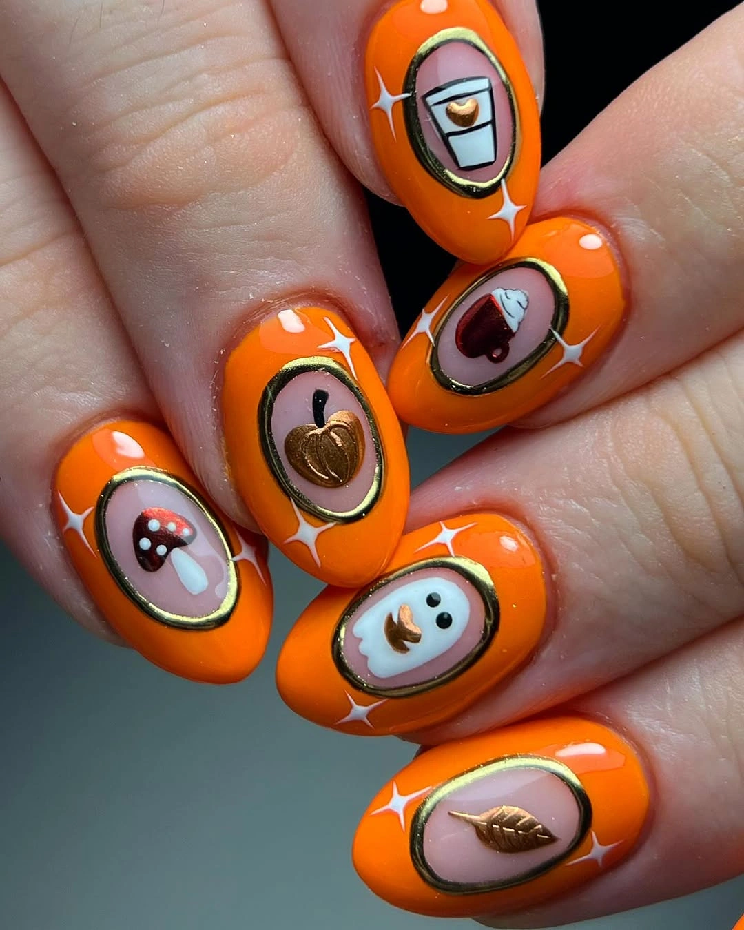 Bright orange nails with framed miniature seasonal scenes