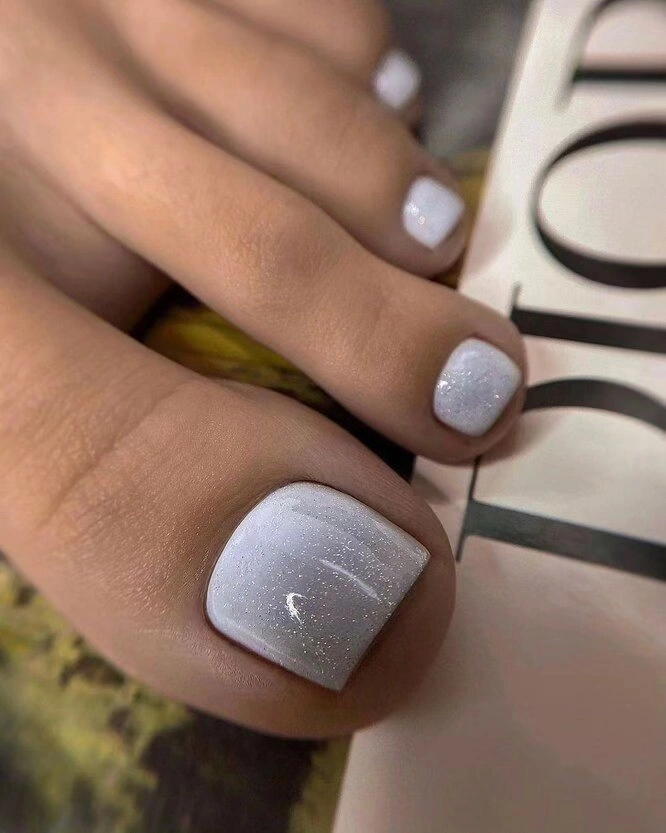 Soft white short toenails with fine shimmer