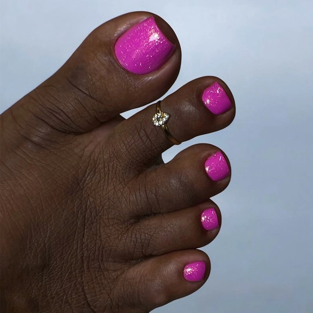 Bright pink sparkle pedicure on short toenails