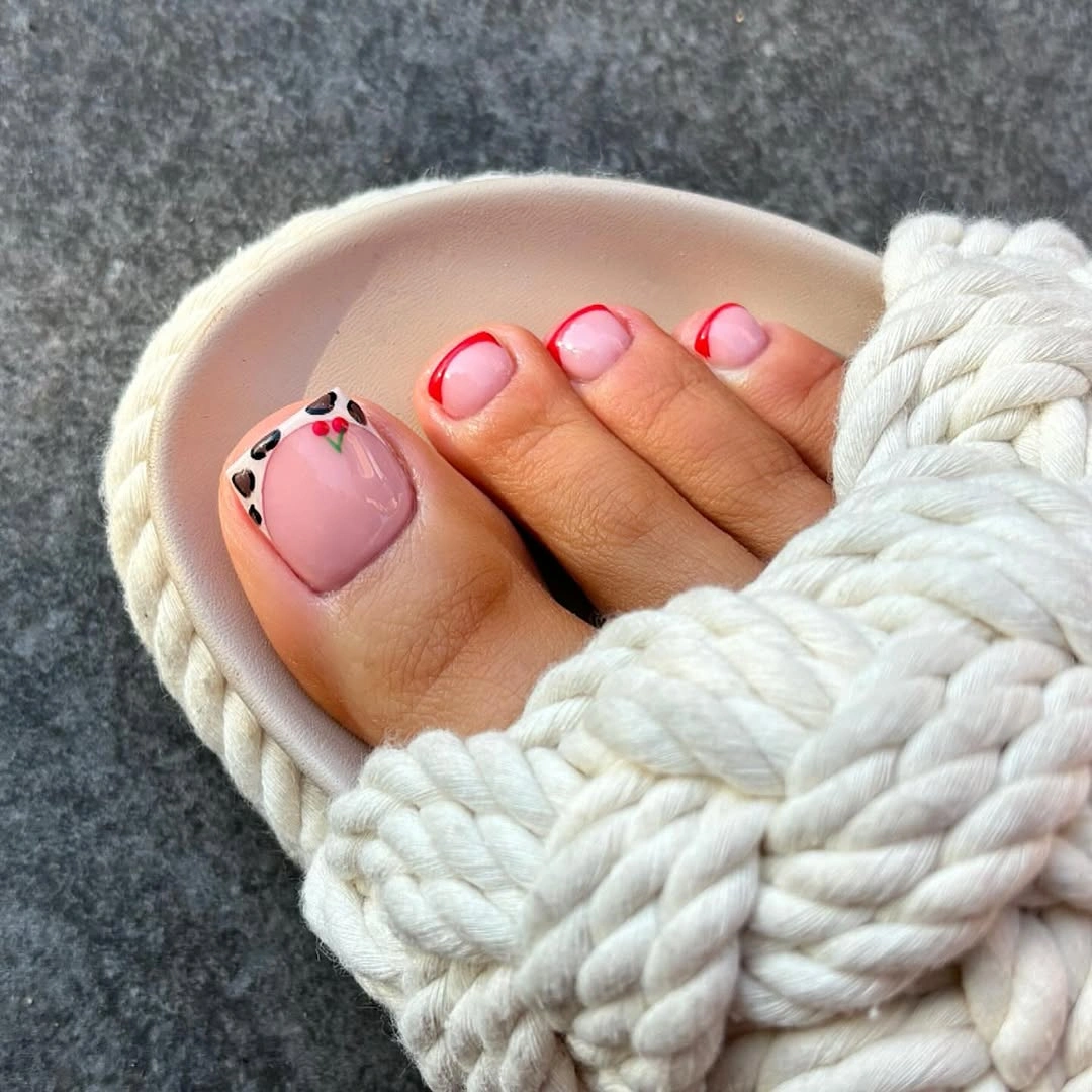 Pale pink pedicure with red French edges