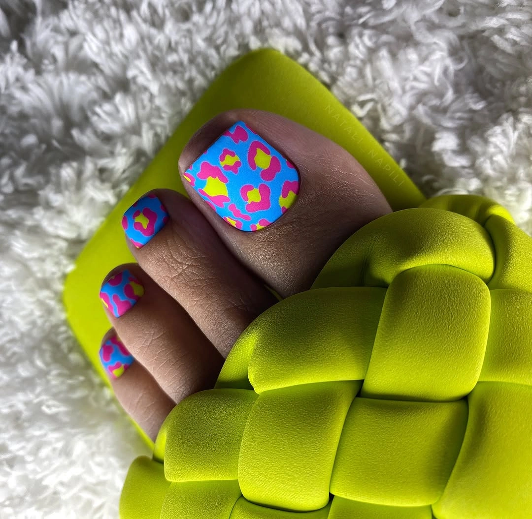 Bright blue toenails with pink yellow leopard spots