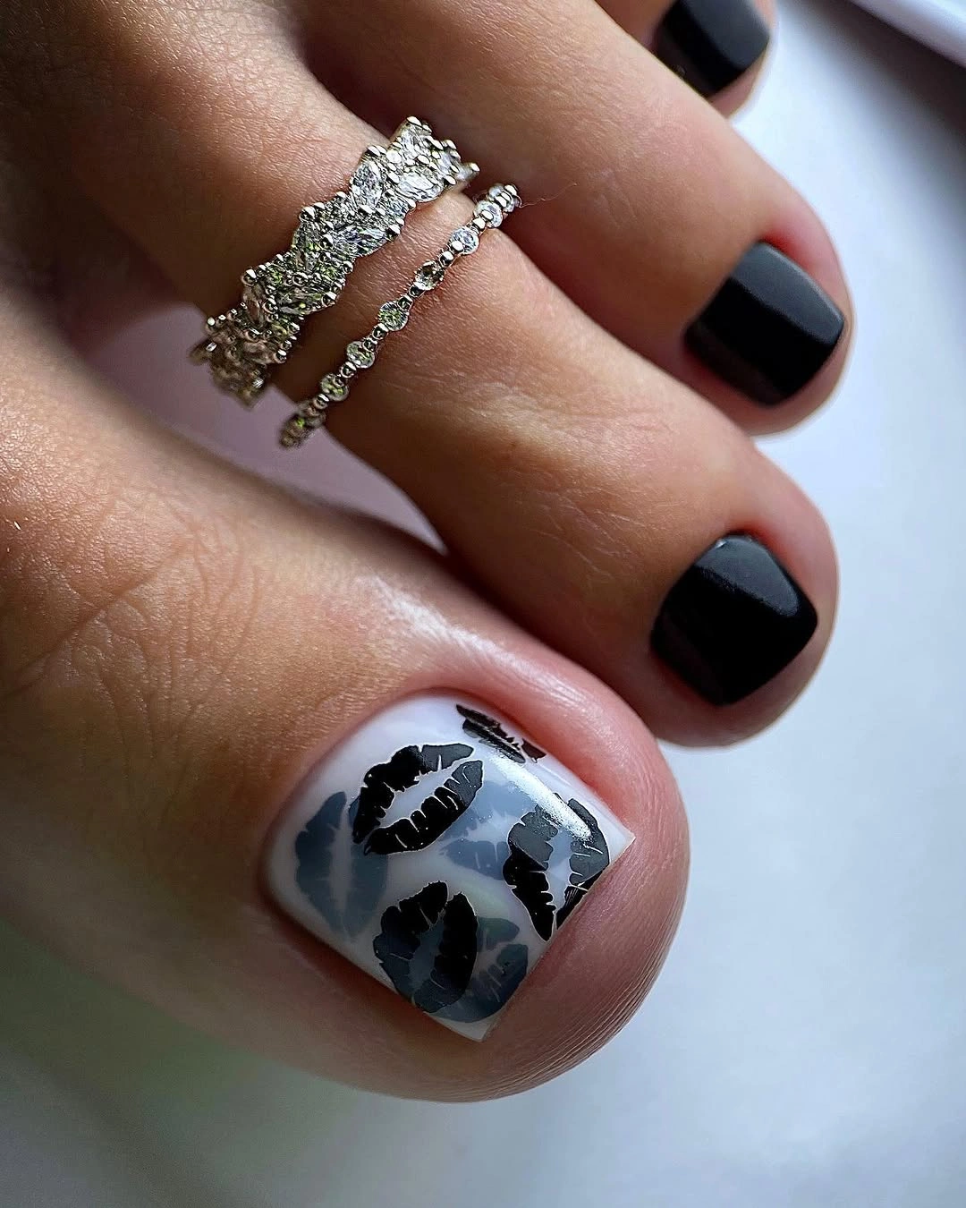 Black pedicure with white graphic big toe accent