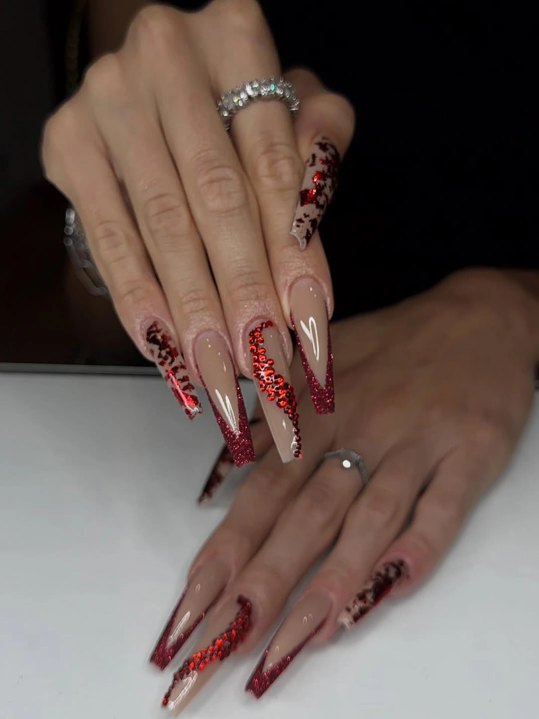 Nude tapered square nails with red sparkle tips