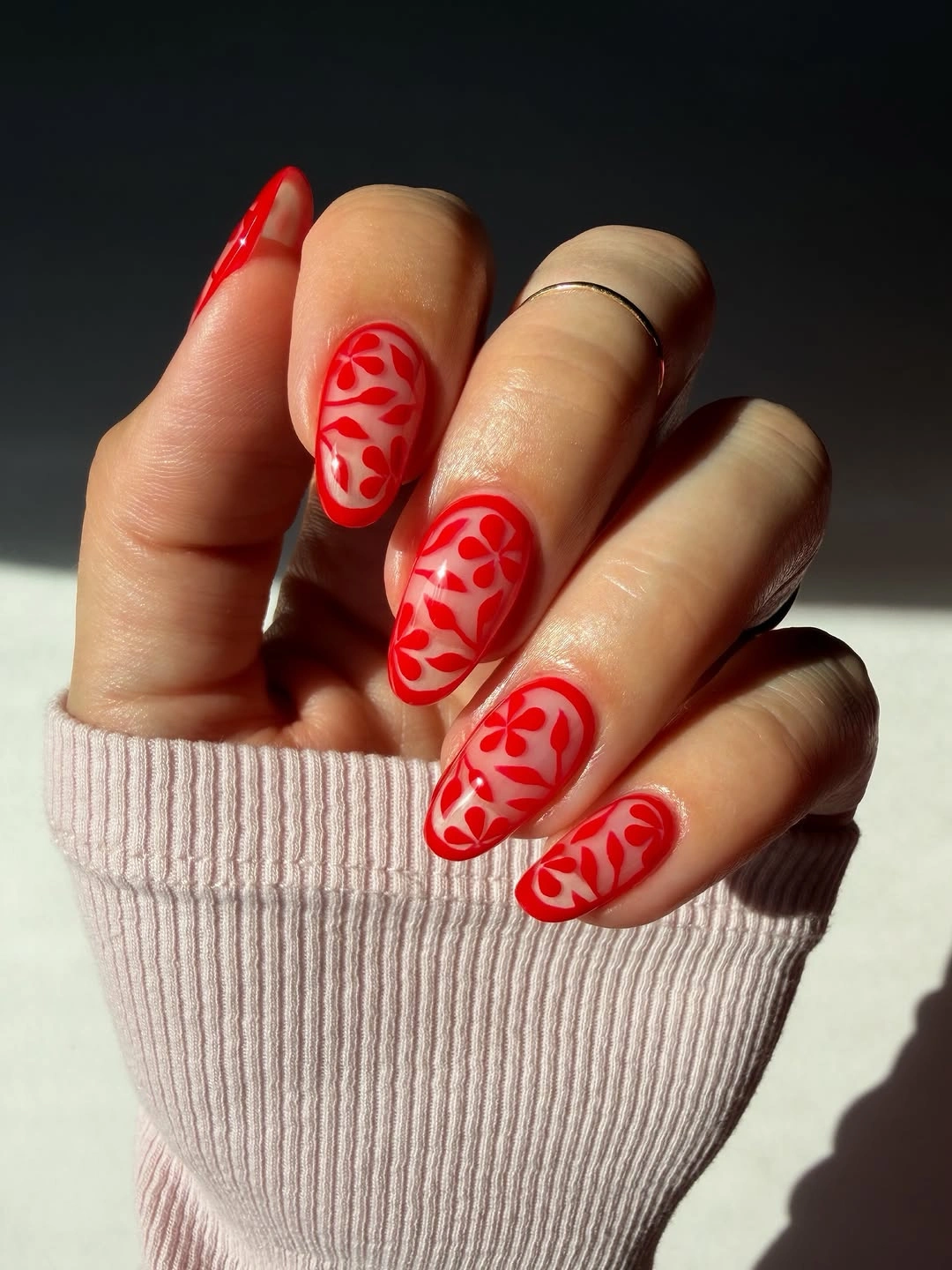 Almond nails with pale base and red floral vines