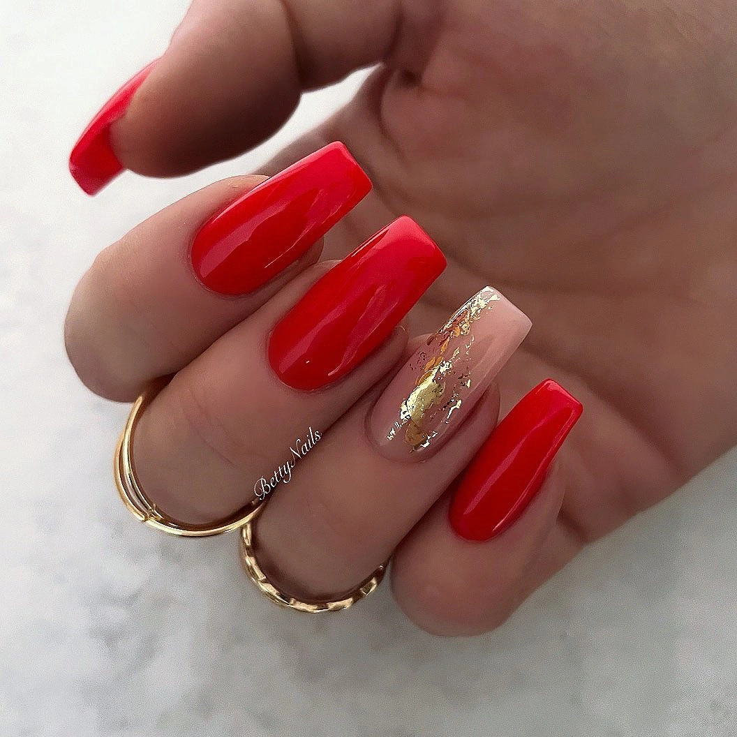 Glossy red square nails with gold-toned nude accent