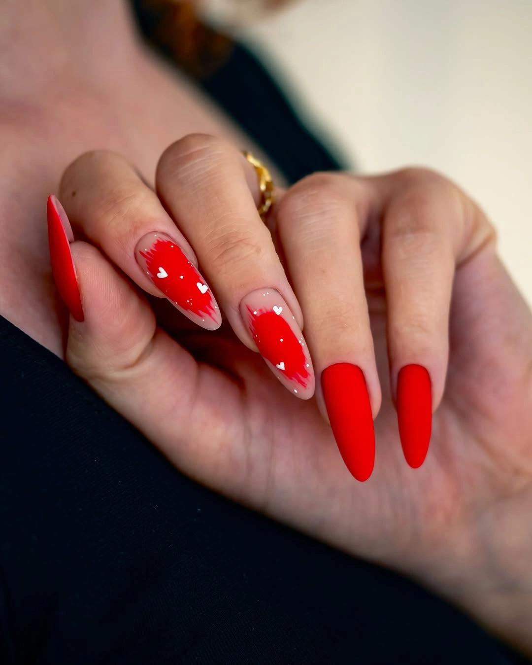 Tapered red nails with nude heart accents