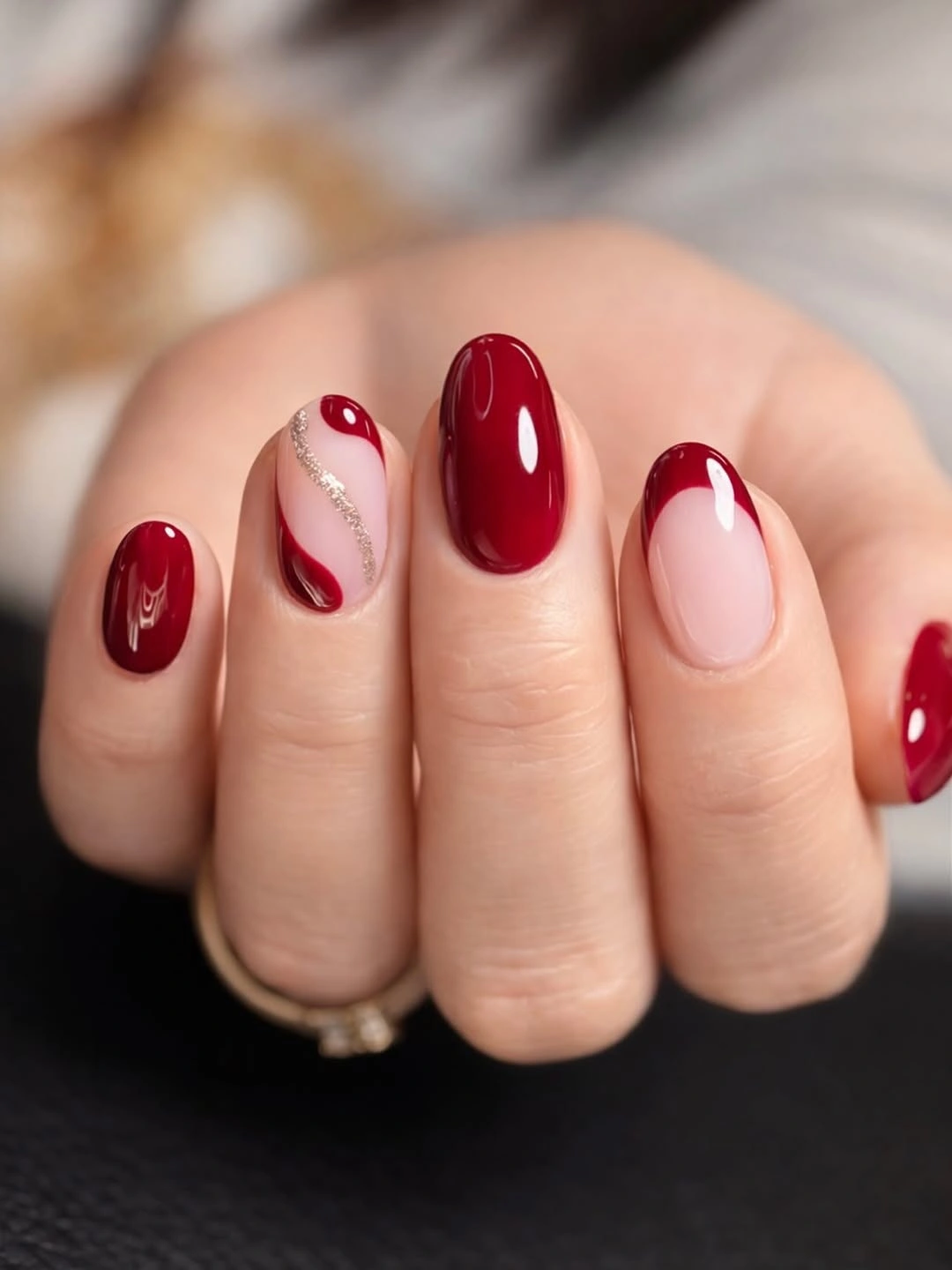 Short burgundy nails with pale curved red accents