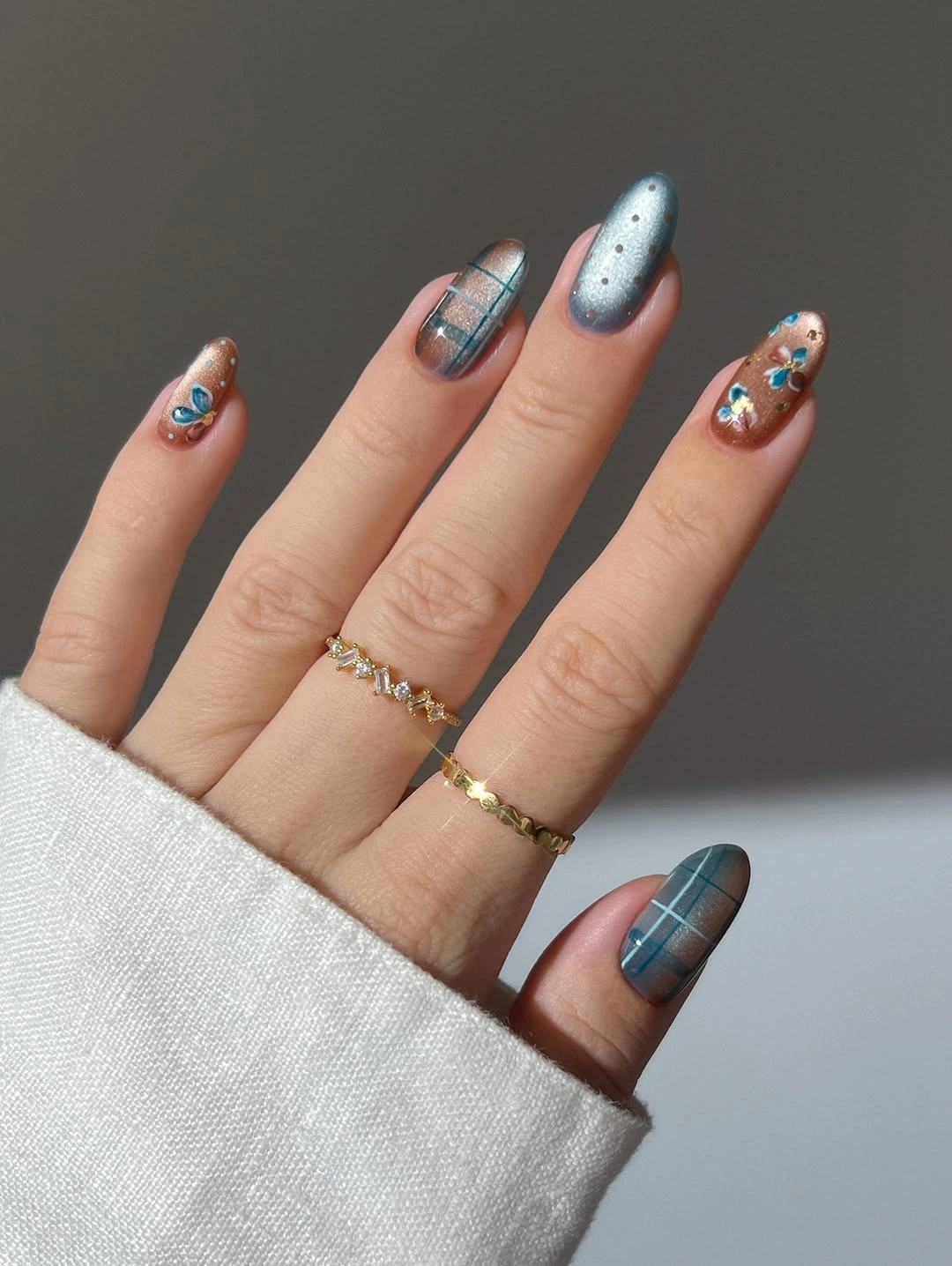 Pale blue short almond nails with plaid and tiny colorful accents