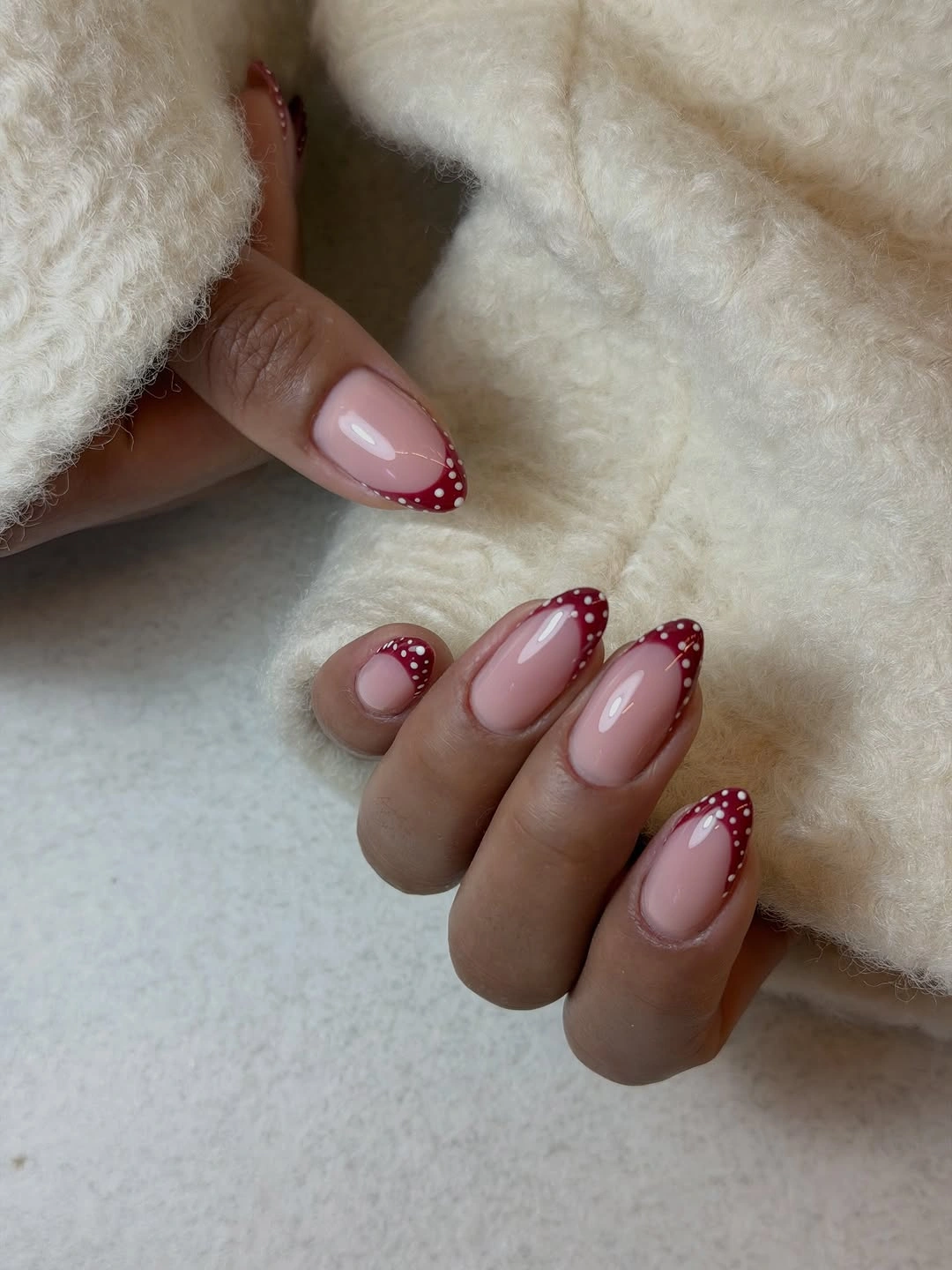 Blush short almond nails with red dotted French edges