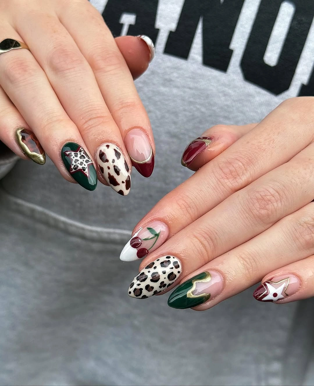 Medium almond nails with pink green burgundy and spotted accents