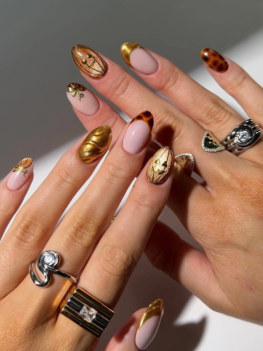 Long almond nails with amber gold and animal print accents