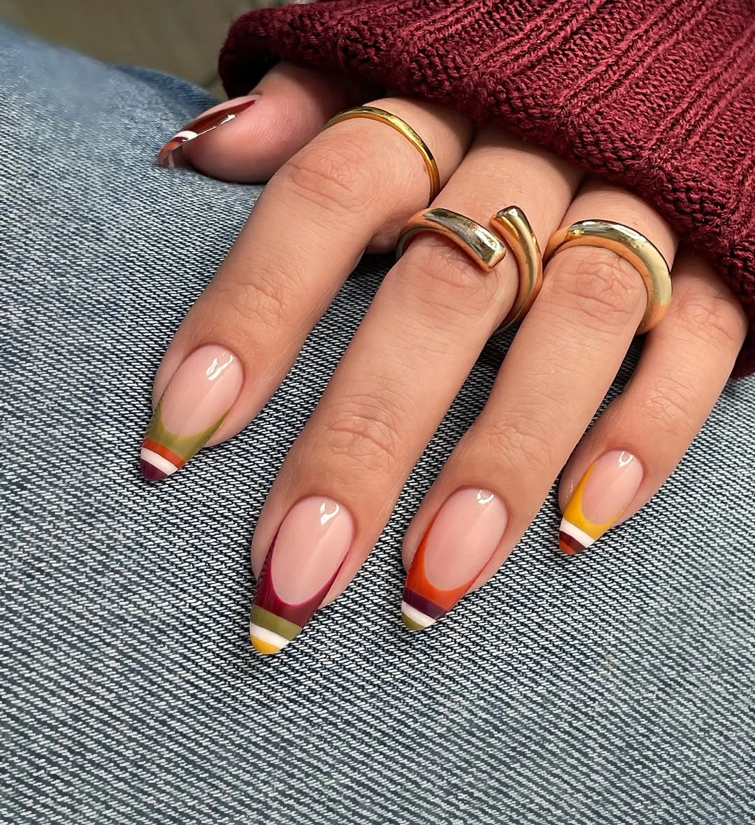 Short almond nails with narrow green yellow and red French tips