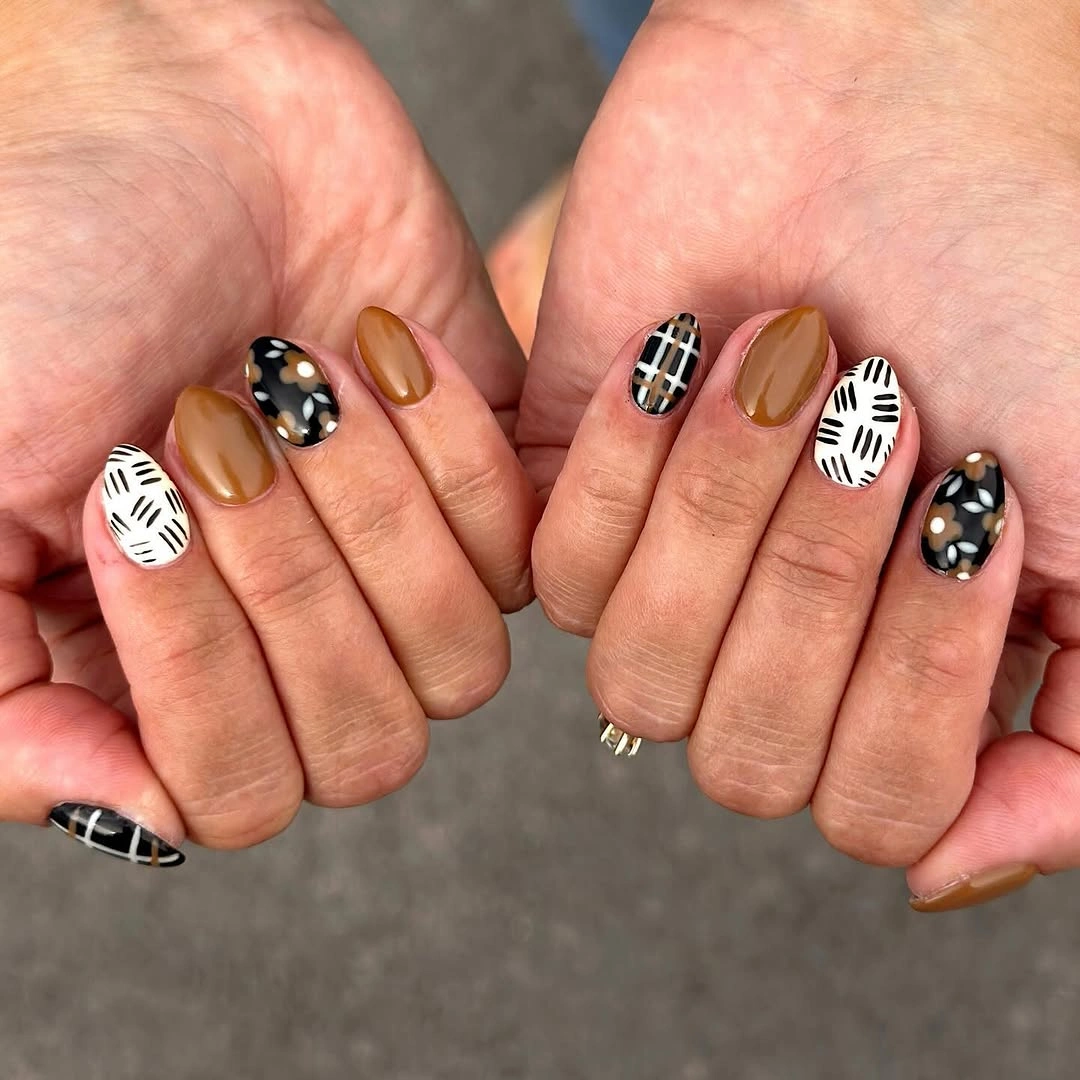 Short almond nails with graphic black white mustard and brown patterns