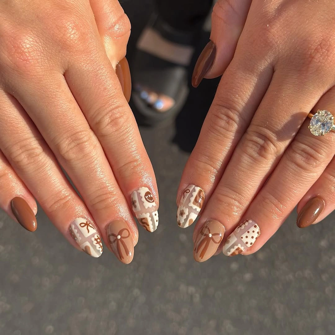 Neutral short almond nails with brown white and floral accents