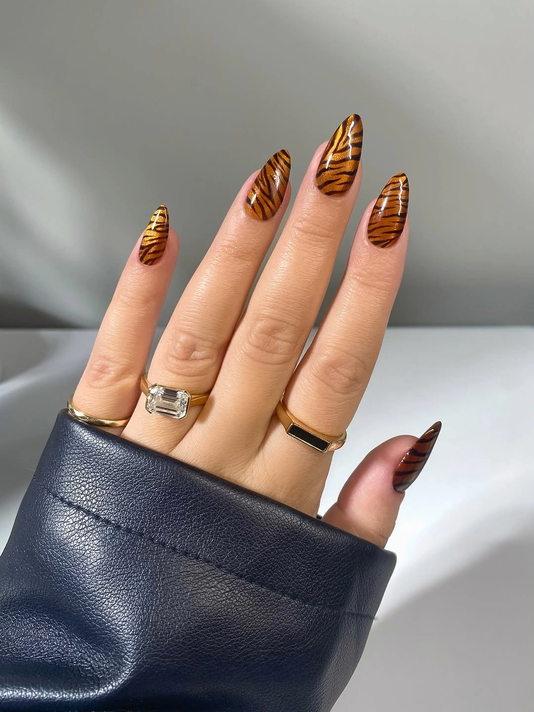 Short almond nails with orange brown tiger stripe accents