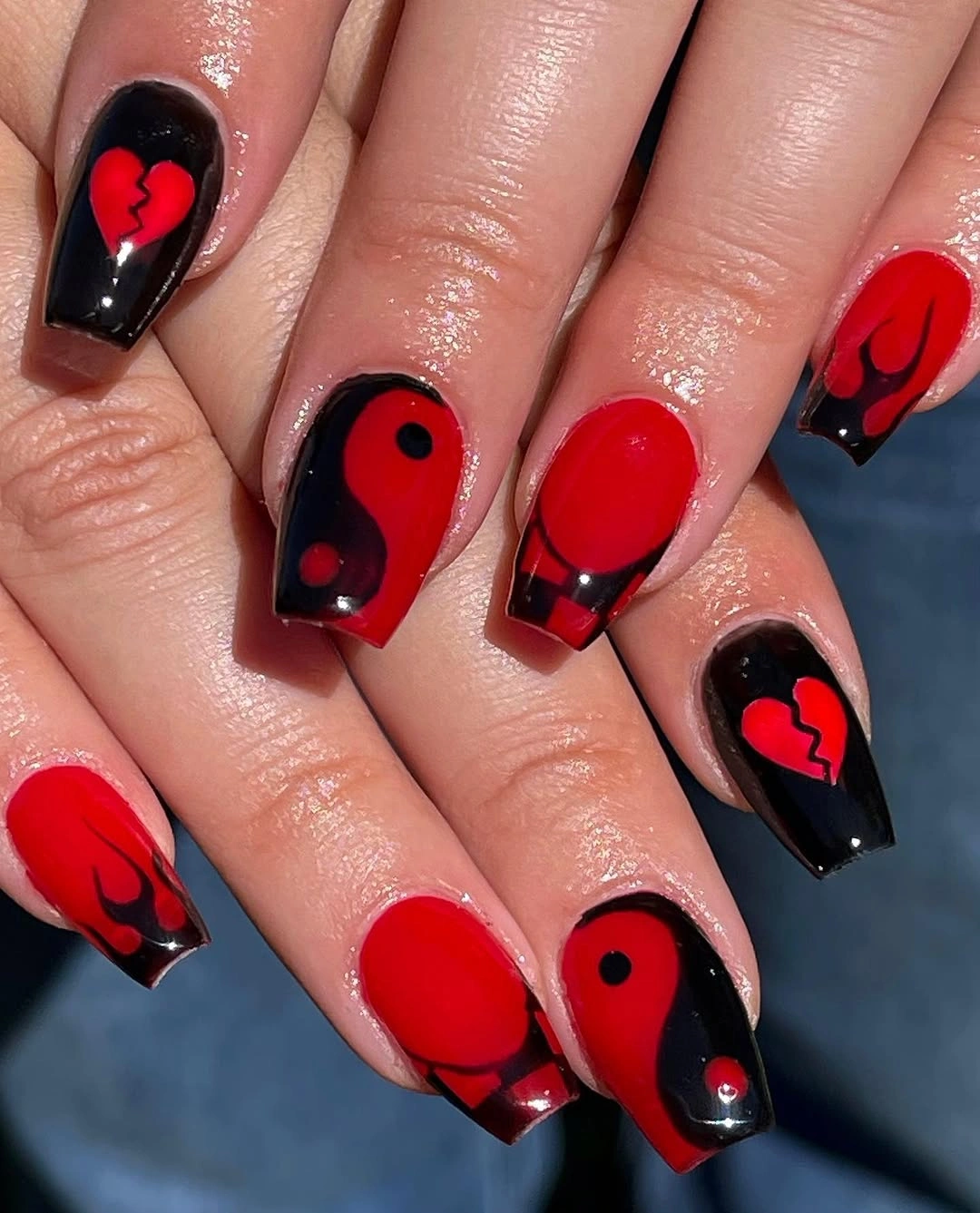 Long square nails with bold red black graphic motifs